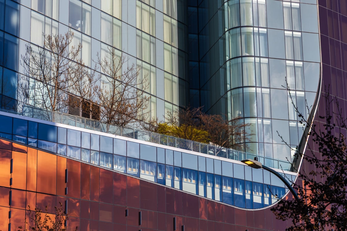 Modern glass office building facade with exterior terrace landscaping in Vancouver